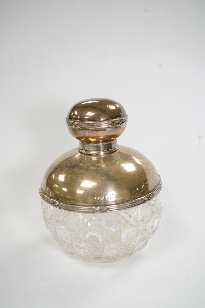 Four assorted mounted glass scent bottles, including three with silver mounts, tallest 11.9cm. Condition - poor